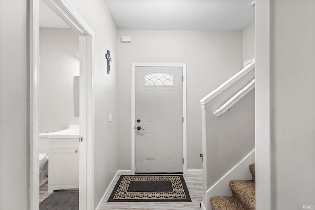 foyer entrance featuring a textured ceiling and hardwood / wood-style flooring