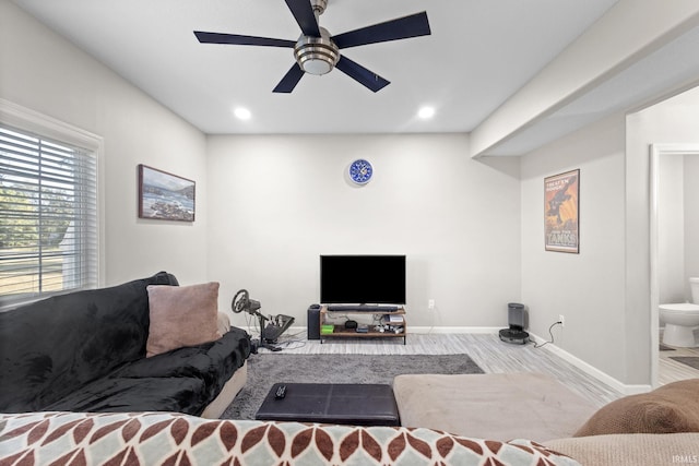 living room featuring light hardwood / wood-style floors and ceiling fan