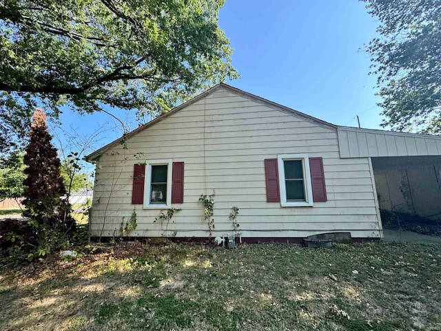 view of property exterior with a lawn