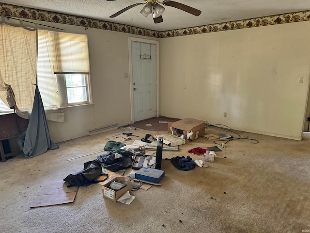 interior space featuring ceiling fan and a textured ceiling