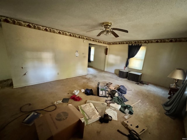 interior space with ceiling fan and a textured ceiling