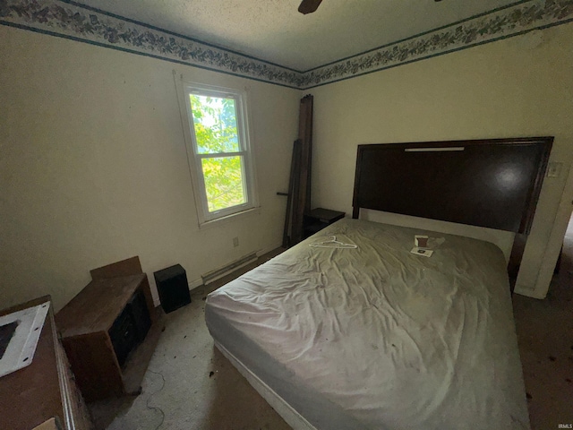 bedroom featuring ceiling fan and a textured ceiling