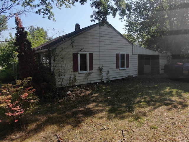 rear view of property featuring a yard