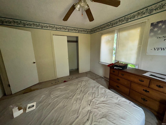 bedroom with a closet, ceiling fan, and a textured ceiling