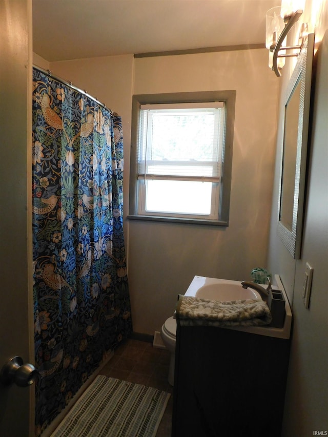 bathroom featuring walk in shower, tile patterned flooring, vanity, and toilet