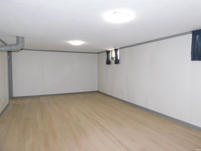 basement with light hardwood / wood-style flooring