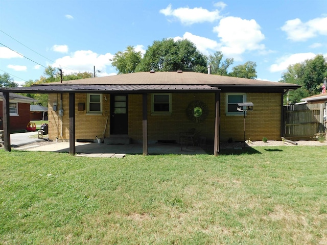 rear view of property with a lawn and a patio area