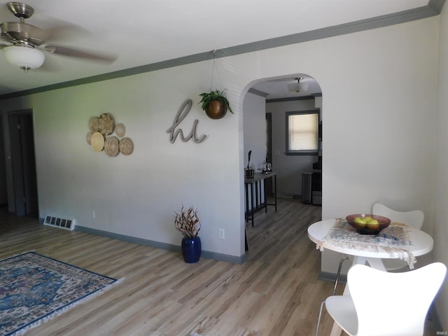 dining room with ceiling fan, hardwood / wood-style flooring, and crown molding