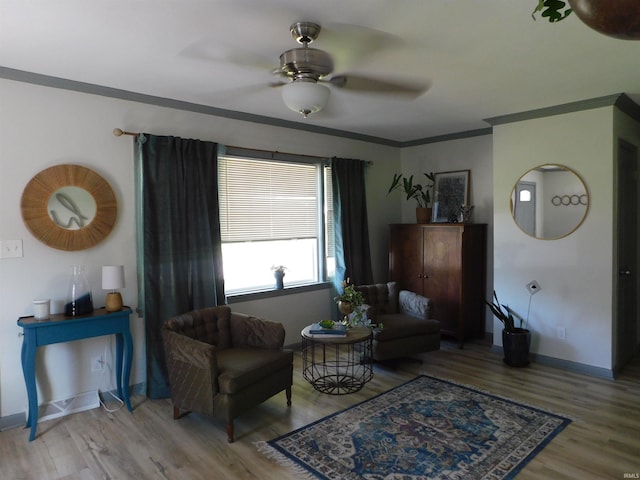 interior space with ornamental molding, wood-type flooring, and ceiling fan