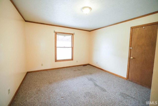 carpeted empty room featuring ornamental molding