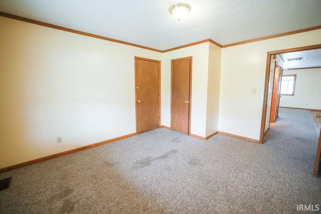 unfurnished bedroom with carpet floors and crown molding