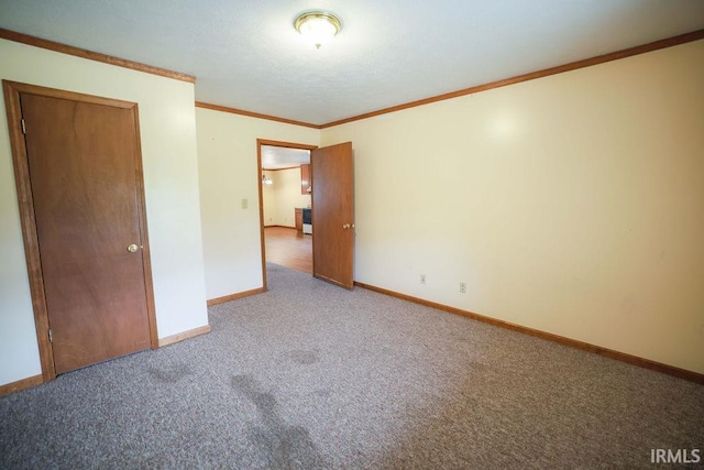 unfurnished bedroom featuring carpet, a closet, and crown molding