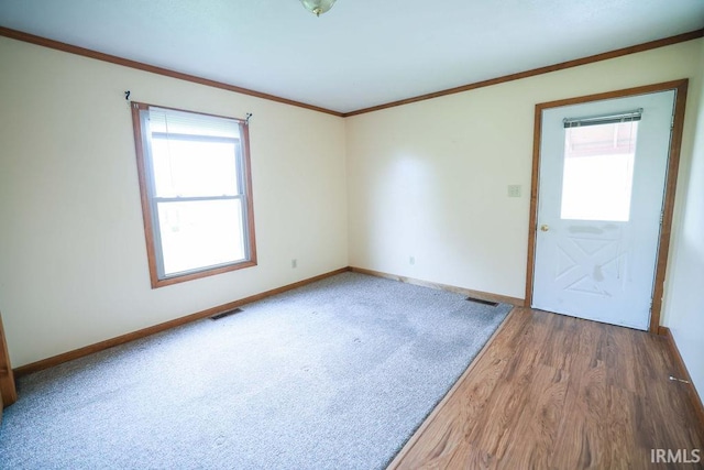 unfurnished room featuring crown molding and hardwood / wood-style floors