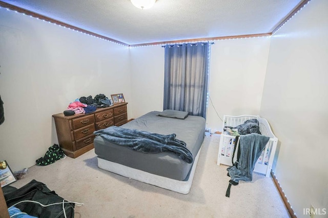 carpeted bedroom featuring a textured ceiling