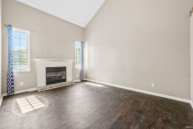 unfurnished living room featuring high vaulted ceiling, a brick fireplace, and dark hardwood / wood-style floors