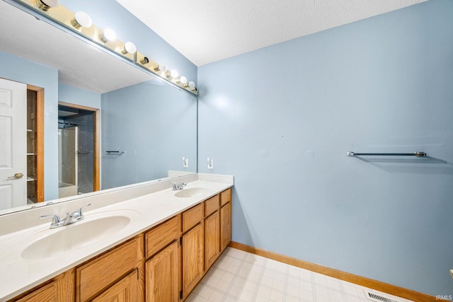 bathroom featuring vanity and a textured ceiling