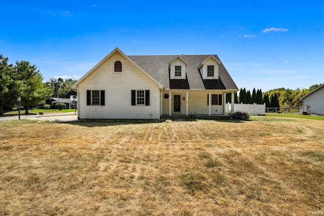 new england style home with a front lawn