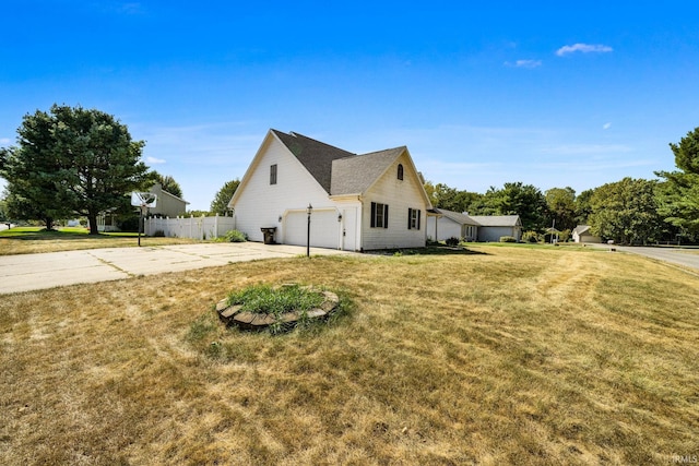 view of home's exterior featuring a lawn and a garage