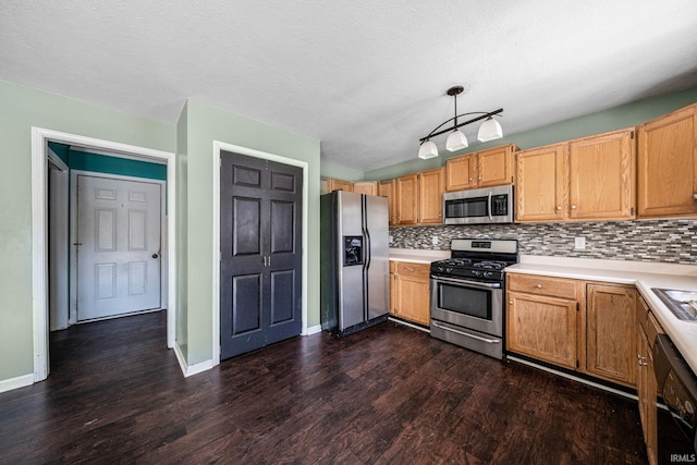 kitchen with a textured ceiling, decorative backsplash, appliances with stainless steel finishes, decorative light fixtures, and dark hardwood / wood-style flooring