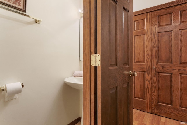 bathroom with hardwood / wood-style flooring