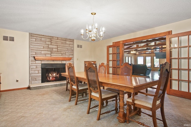 dining space with a notable chandelier, carpet, a textured ceiling, and a fireplace