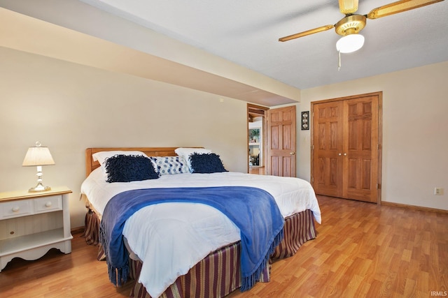 bedroom featuring ceiling fan, light hardwood / wood-style flooring, and a closet