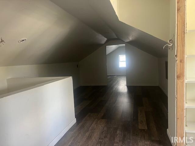 additional living space with lofted ceiling and dark hardwood / wood-style floors