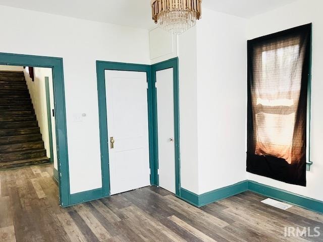 interior space featuring a chandelier and dark hardwood / wood-style flooring