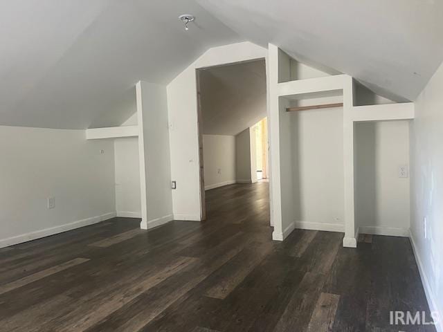 additional living space with lofted ceiling and dark wood-type flooring