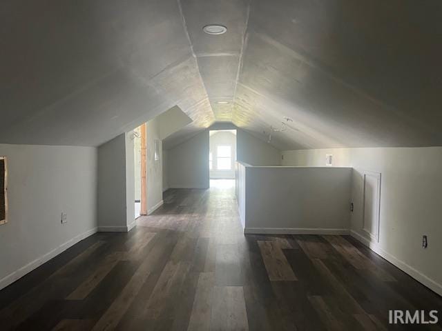 bonus room featuring lofted ceiling and dark wood-type flooring