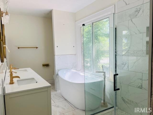 full bathroom featuring vanity, shower with separate bathtub, and toilet