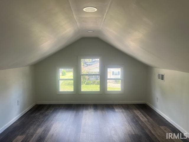 bonus room featuring lofted ceiling and dark wood-type flooring