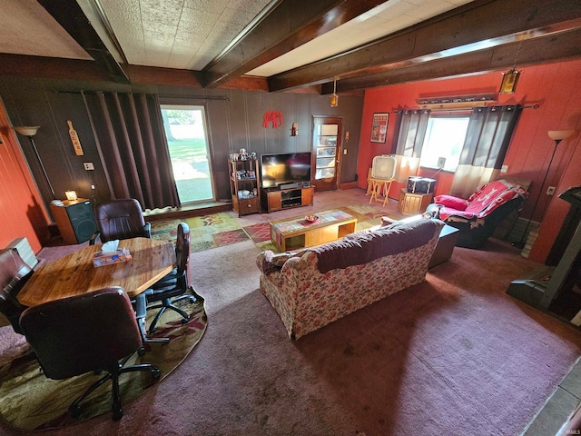 living room featuring beam ceiling and carpet