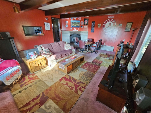 living room with wooden walls, beam ceiling, and carpet floors