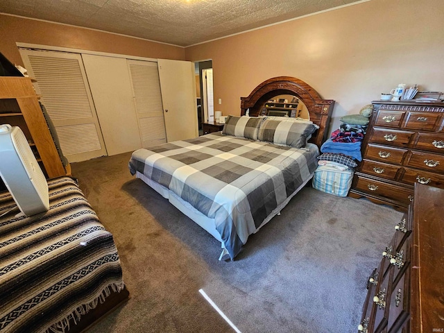 bedroom featuring a closet, a fireplace, carpet flooring, and a textured ceiling