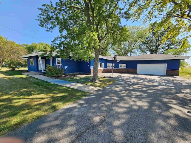 view of front of house with a garage and a front yard