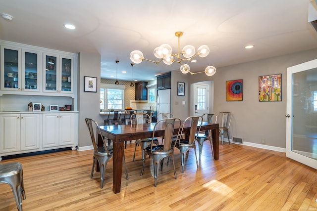 dining room featuring an inviting chandelier and light hardwood / wood-style floors