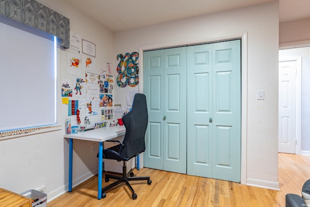 office area with light hardwood / wood-style floors