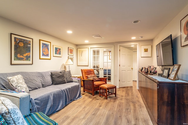 living room with light hardwood / wood-style floors and french doors