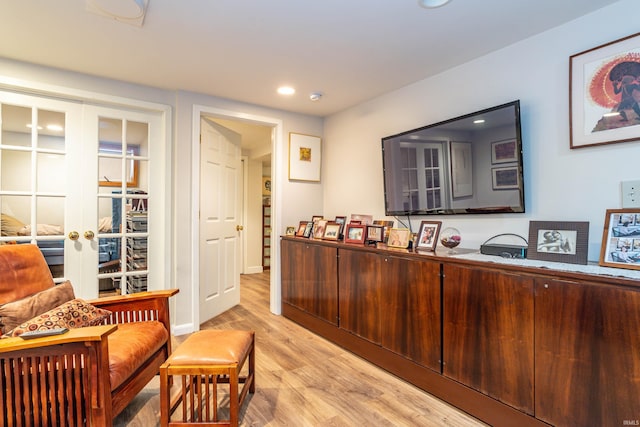 interior space with light hardwood / wood-style flooring and french doors