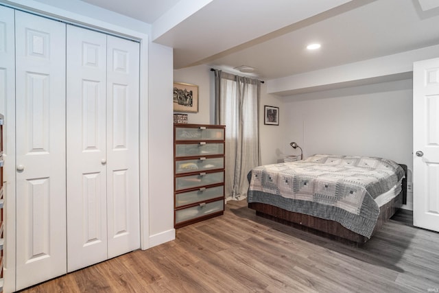 bedroom featuring wood-type flooring and a closet