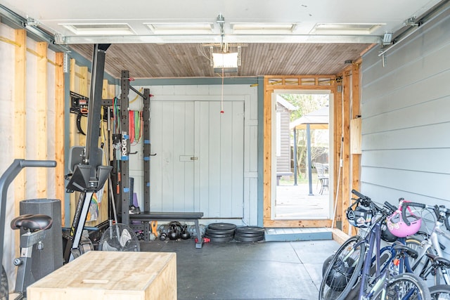 garage featuring a garage door opener and wooden walls