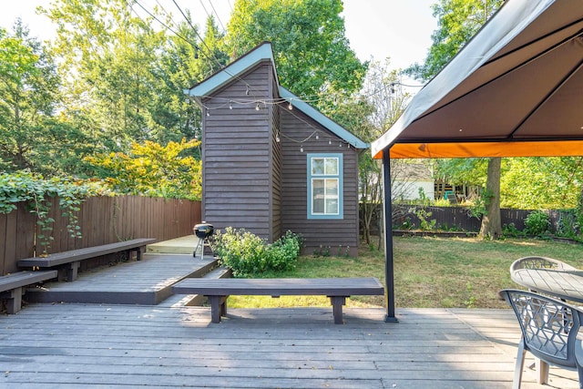 wooden terrace featuring a lawn