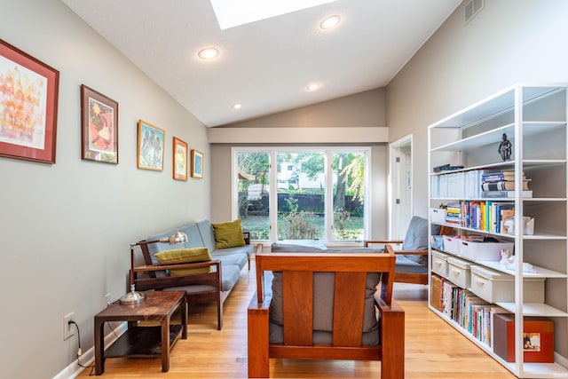 home office featuring wood-type flooring and lofted ceiling with skylight