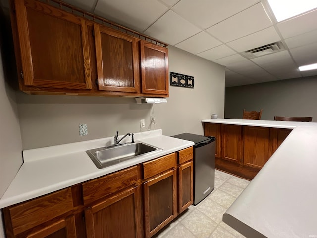 kitchen featuring sink and a paneled ceiling