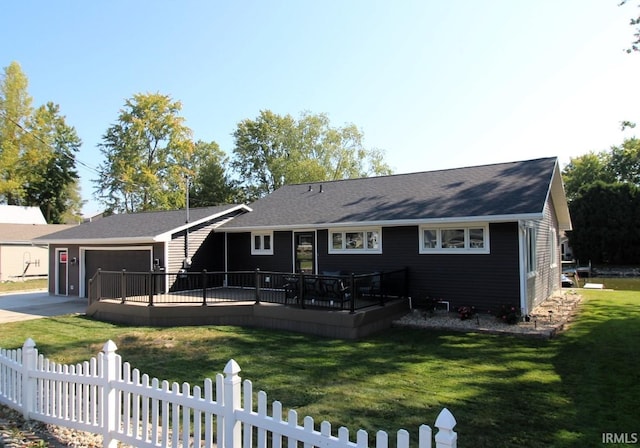 rear view of property featuring a wooden deck and a lawn