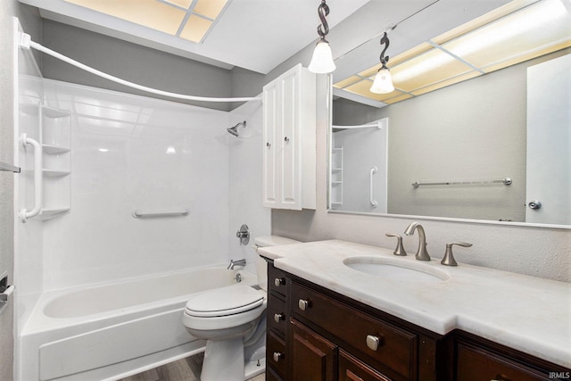 full bathroom with hardwood / wood-style floors, shower / washtub combination, vanity, and toilet