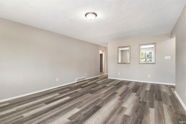 empty room featuring dark hardwood / wood-style flooring