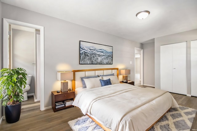 bedroom with dark hardwood / wood-style flooring