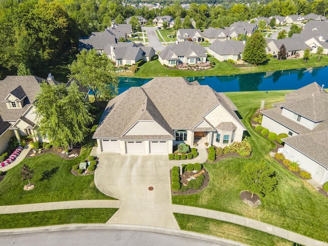 drone / aerial view featuring a residential view and a water view